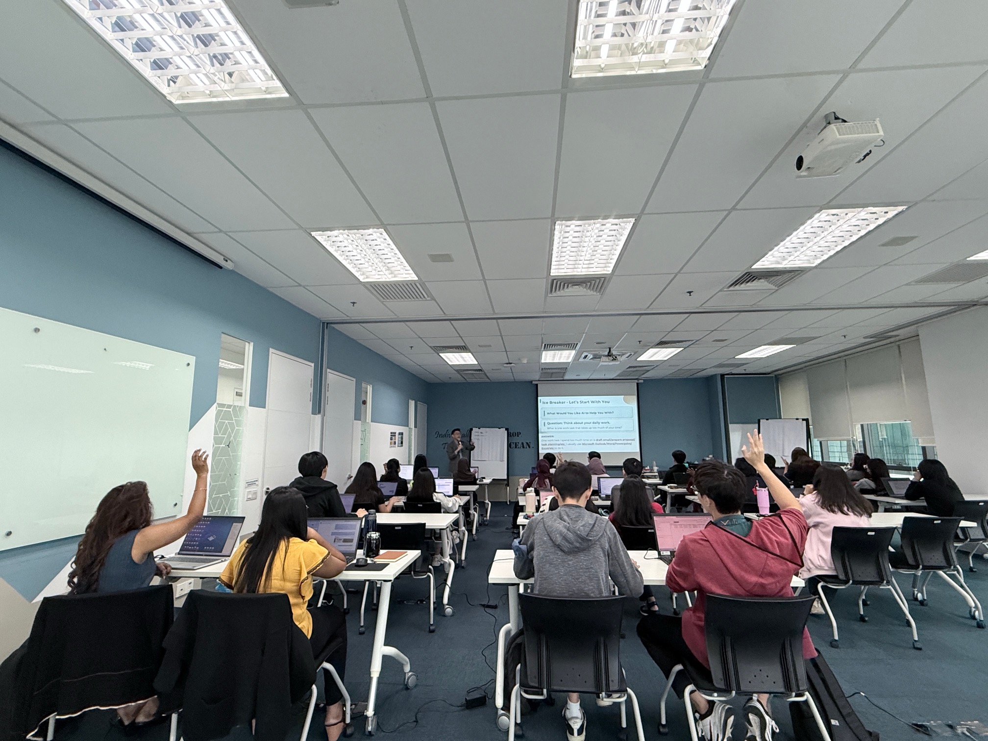 Interactive AI training session with participants using laptops